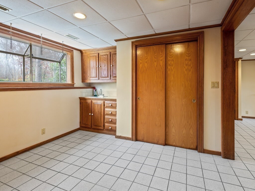 21 Hutchinson Road Sutton, MA 01590 - Photo 28 of 41 a view of an empty room with window and cabinet