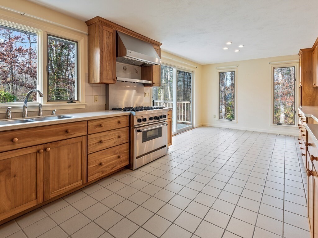 21 Hutchinson Road Sutton, MA 01590 - Photo 8 of 41 a kitchen with stainless steel appliances a sink stove and cabinets