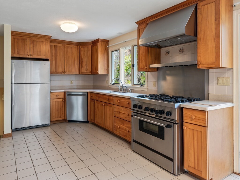 21 Hutchinson Road Sutton, MA 01590 - Photo 9 of 41 a kitchen with a stove top oven cabinets and a refrigerator