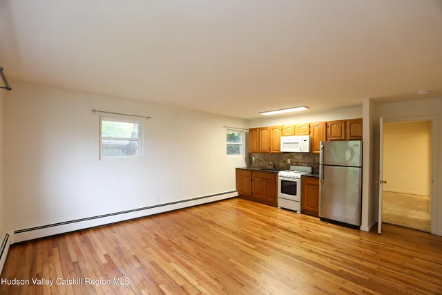 a view of a kitchen with a sink stove refrigerator and a window