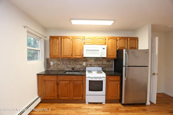 a kitchen with a stove a refrigerator and a sink
