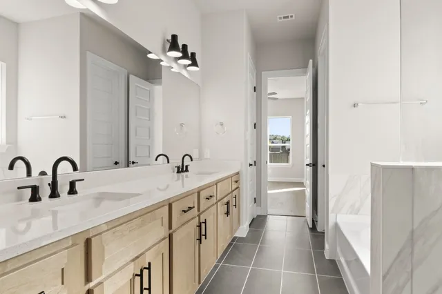 a bathroom with a double vanity sink and mirror with shower