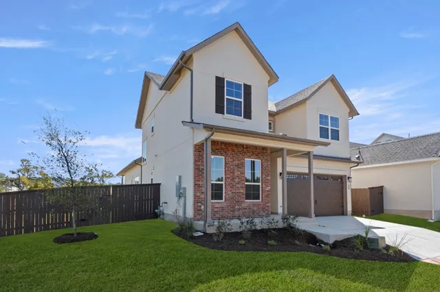 a view of a house with a yard and pathway