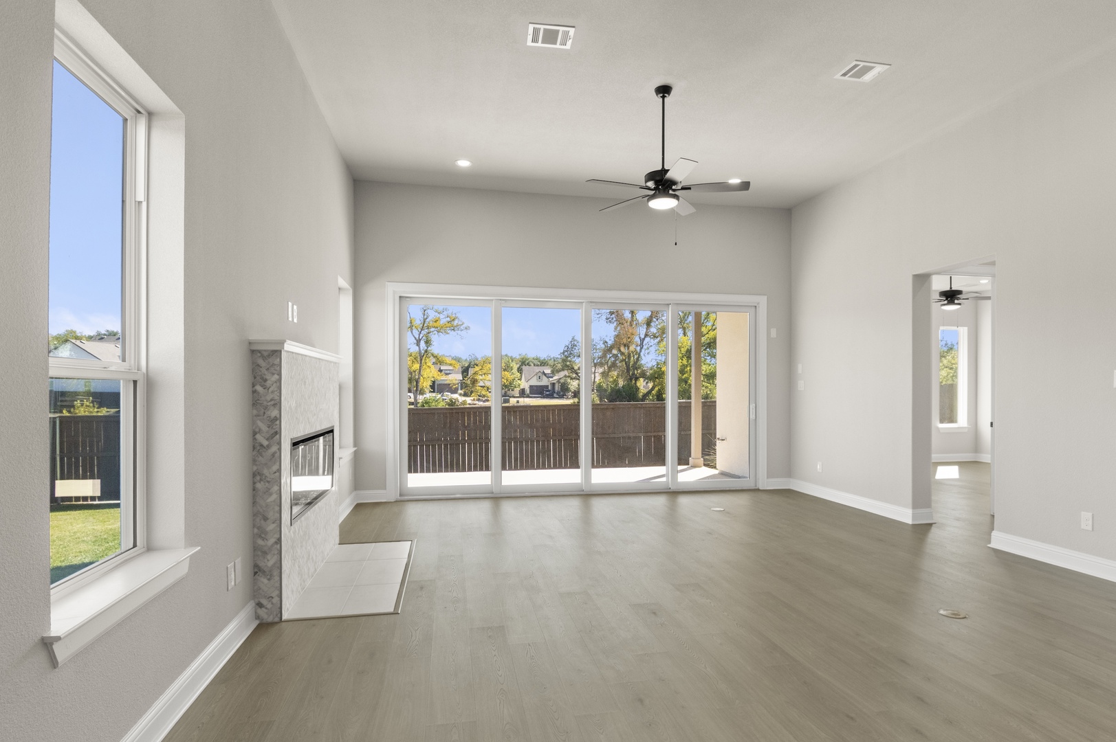 601 C-Bar Ranch Trail, Unit 59 Cedar Park, TX 78613 - Photo 7 of 34 Unfurnished living room with wood finished floors, a fireplace, a ceiling fan, and recessed lighting