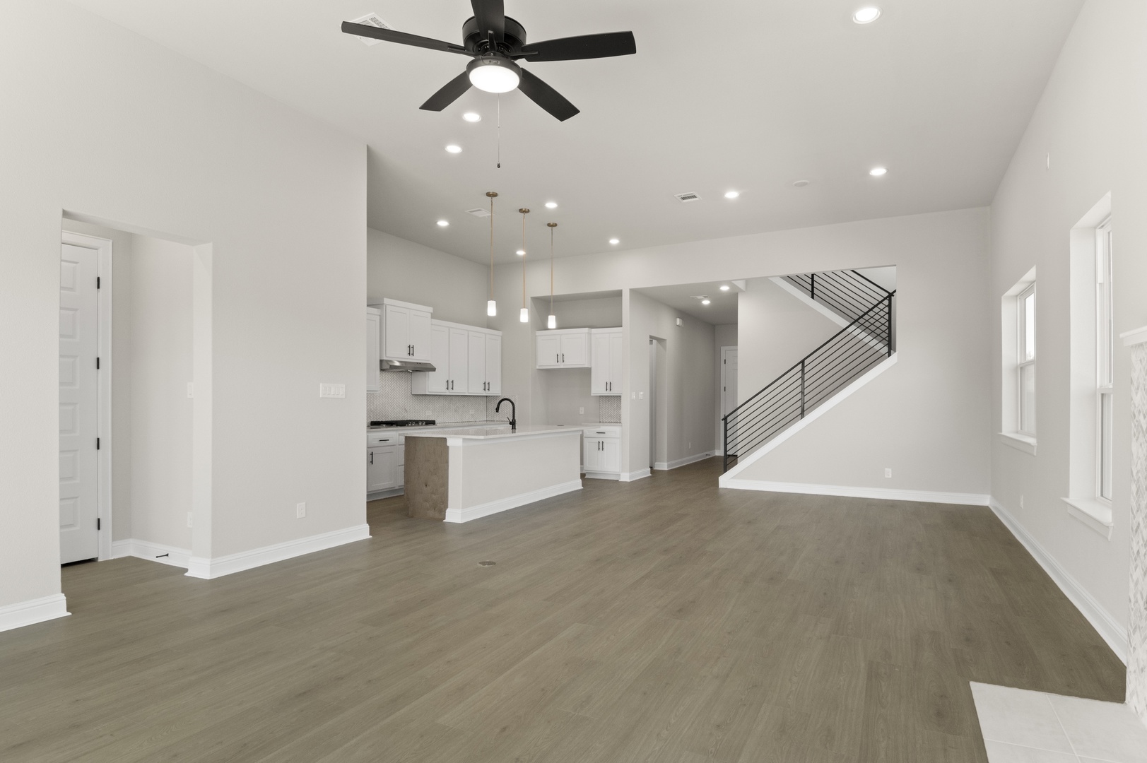 601 C-Bar Ranch Trail, Unit 59 Cedar Park, TX 78613 - Photo 10 of 34 Unfurnished living room featuring stairway, recessed lighting, ceiling fan, and light wood-type flooring