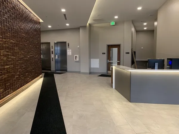 a lobby with furniture and a rug