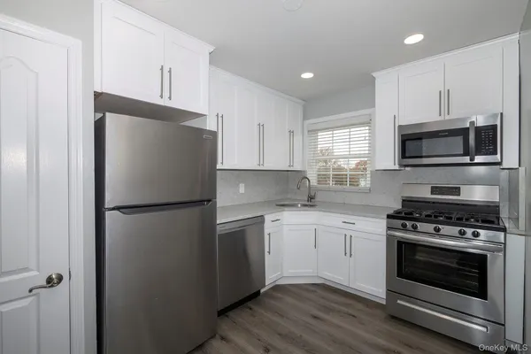 a kitchen with a refrigerator sink and stove top oven
