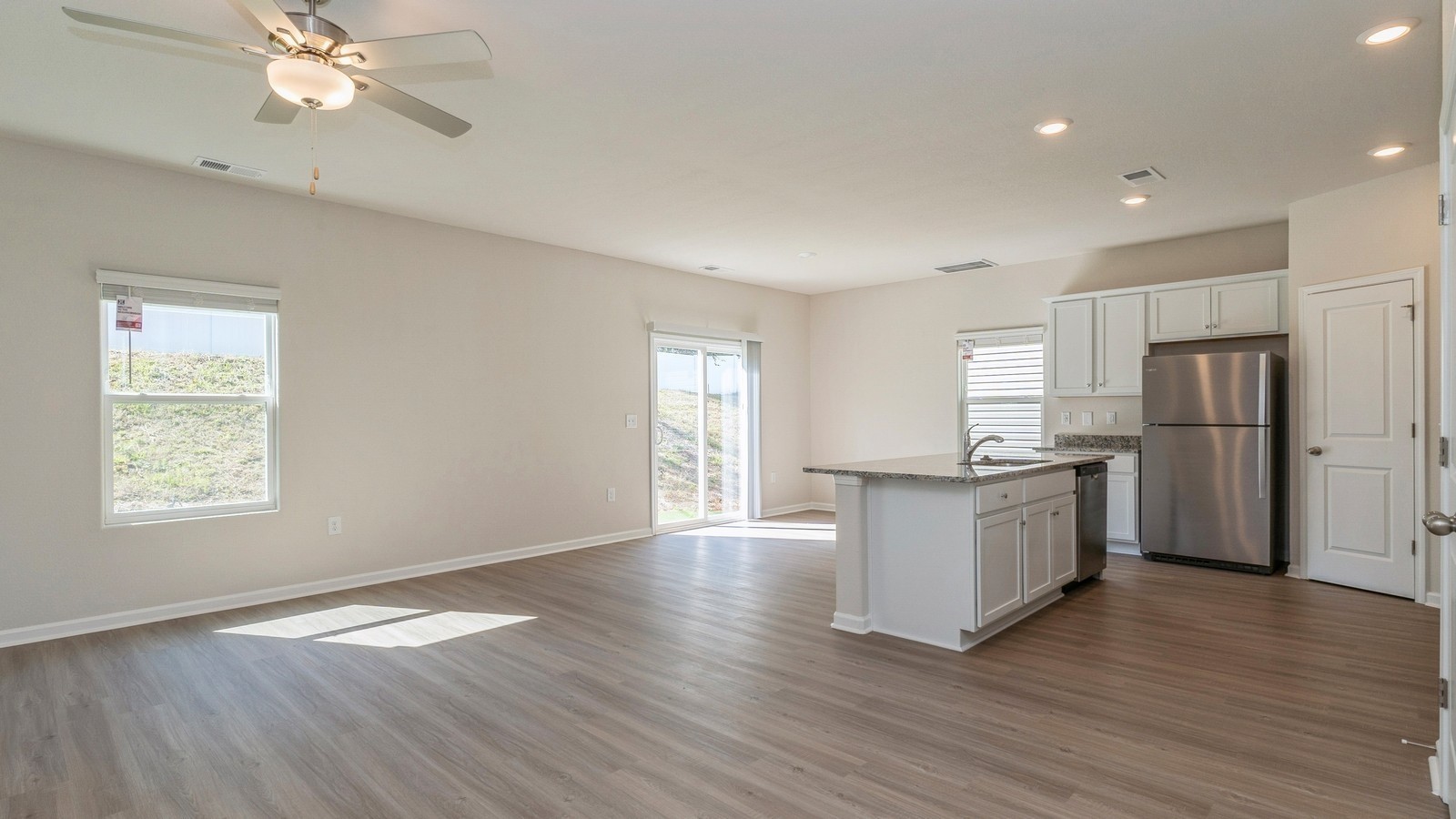 2309 Nabali Way Murfreesboro, TN 37127 - Photo 8 of 38 a kitchen with stainless steel appliances granite countertop a refrigerator a sink dishwasher a stove and white countertops with wooden floor
