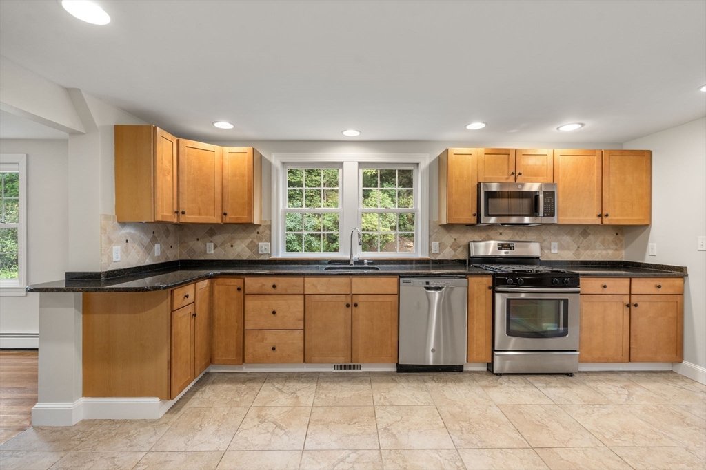 92 Abbot Street Andover, MA 01810 - Photo 8 of 35 a kitchen with stainless steel appliances granite countertop a stove sink and cabinets