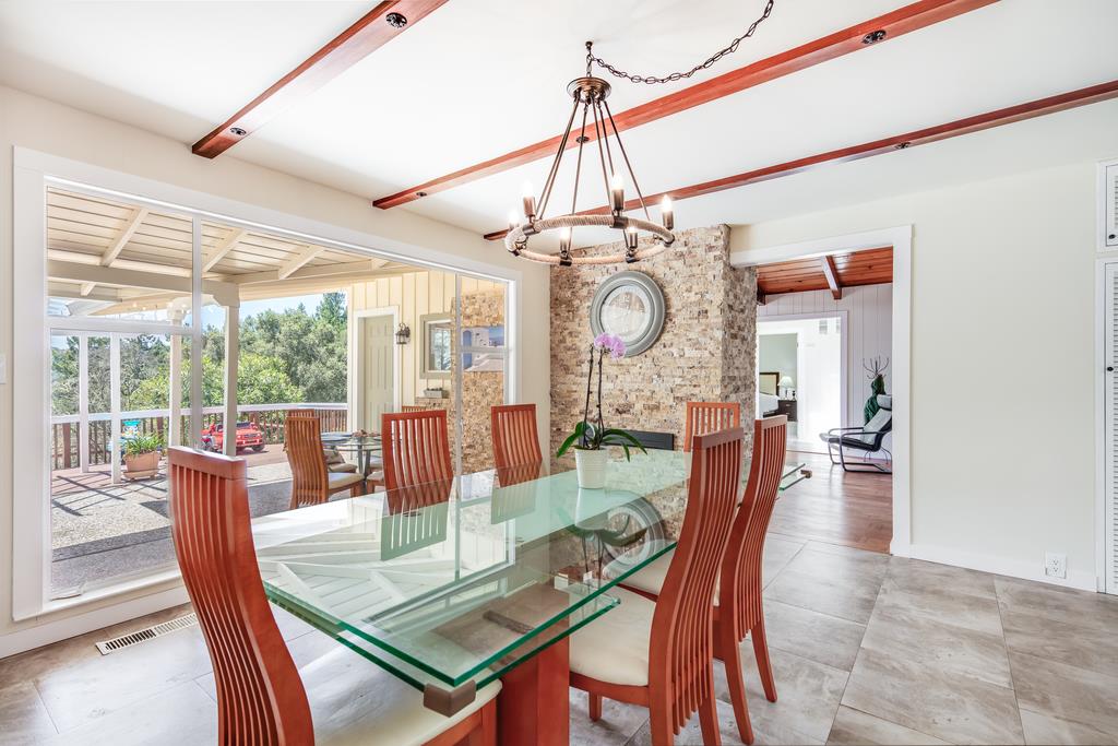 22930 Summit Road Los Gatos, CA 95033 - Photo 14 of 50 a dining room with wooden floor a glass table and chairs