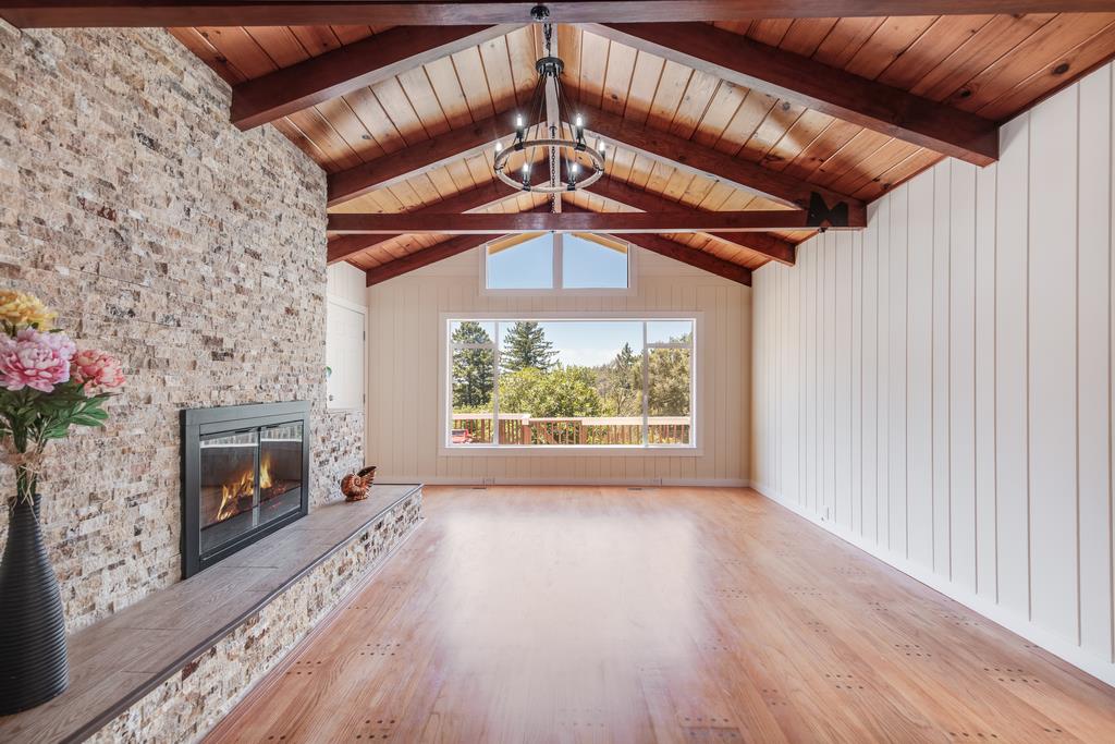 22930 Summit Road Los Gatos, CA 95033 - Photo 8 of 50 a view of a livingroom with a fireplace wooden floor and windows