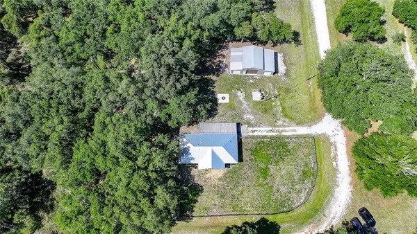 an aerial view of a house with a yard and lake view