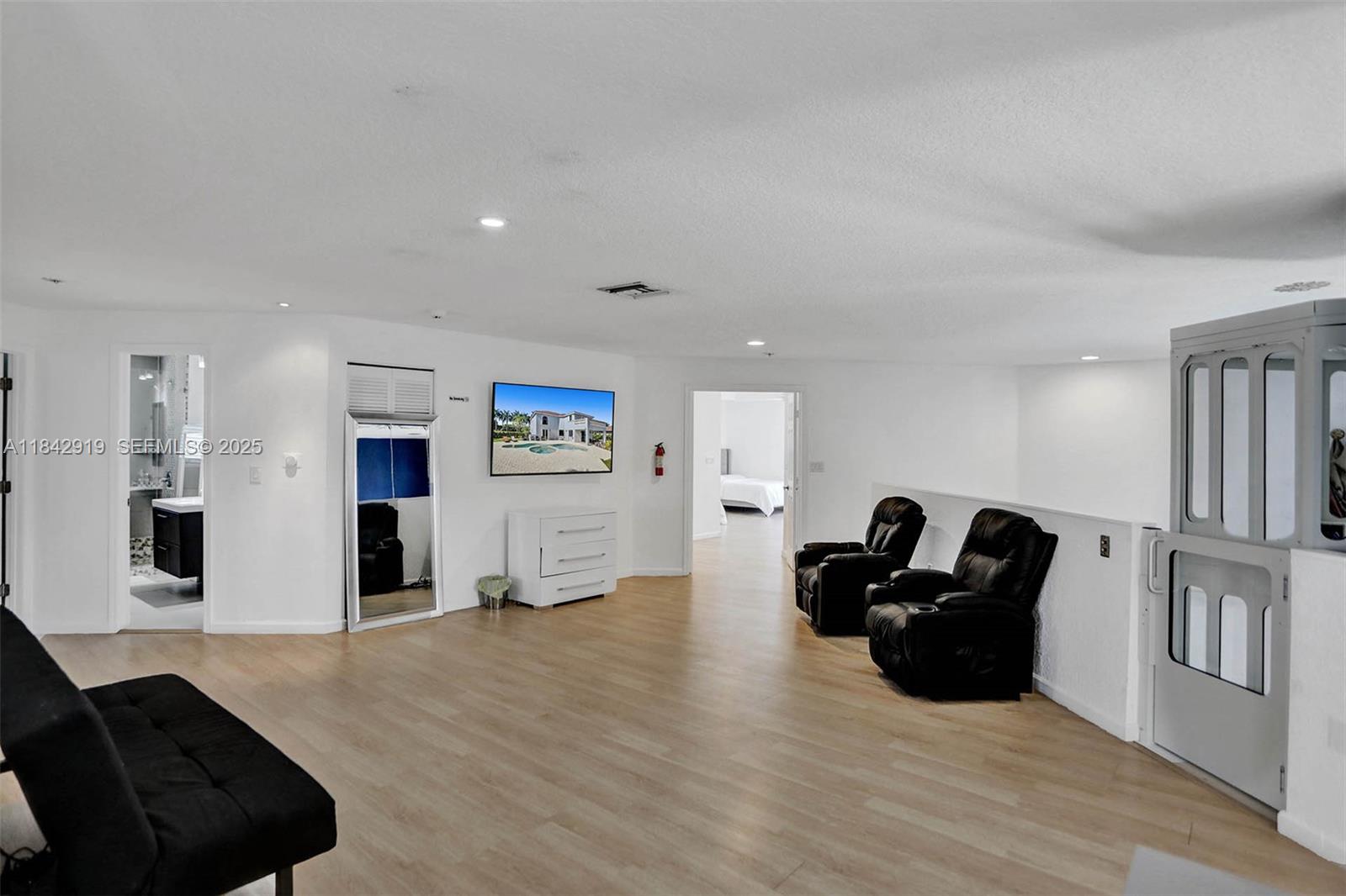 721 Ranch Road Weston, FL 33326 - Photo 22 of 38 a living room with furniture and a flat screen tv