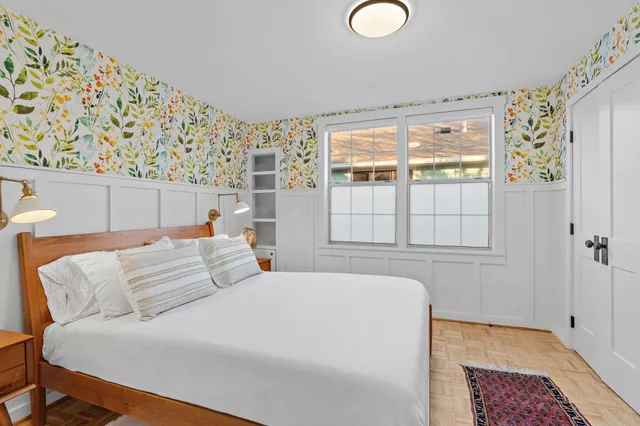 a bedroom with a large bed and a window