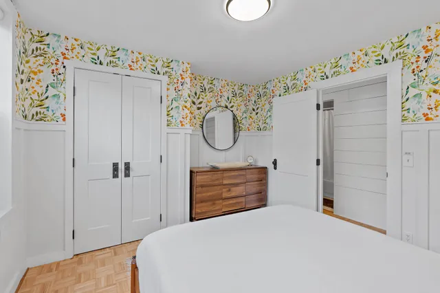 a bedroom with a bed and a dresser