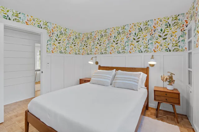 a bedroom with a bed and a chair in it