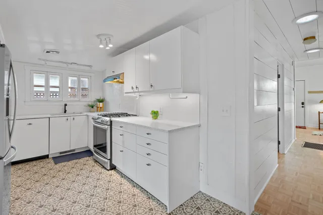 a kitchen with a sink and cabinets