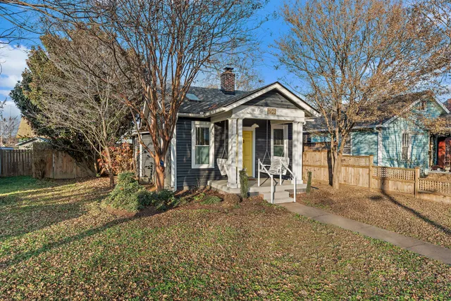 a view of a house with a yard covered in snow