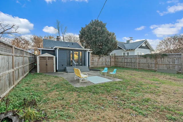 a view of a backyard with a tree