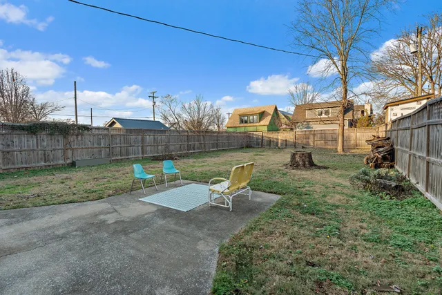 a view of a chair and table in backyard