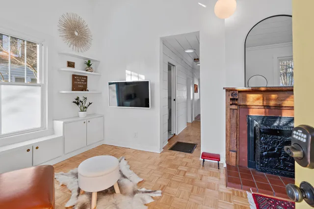 a living room with furniture a flat screen tv and a table