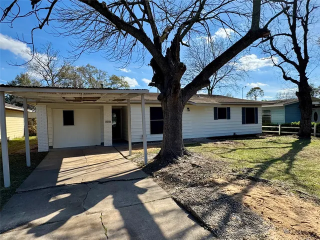 a backyard of a house with wooden floor outdoor seating and yard