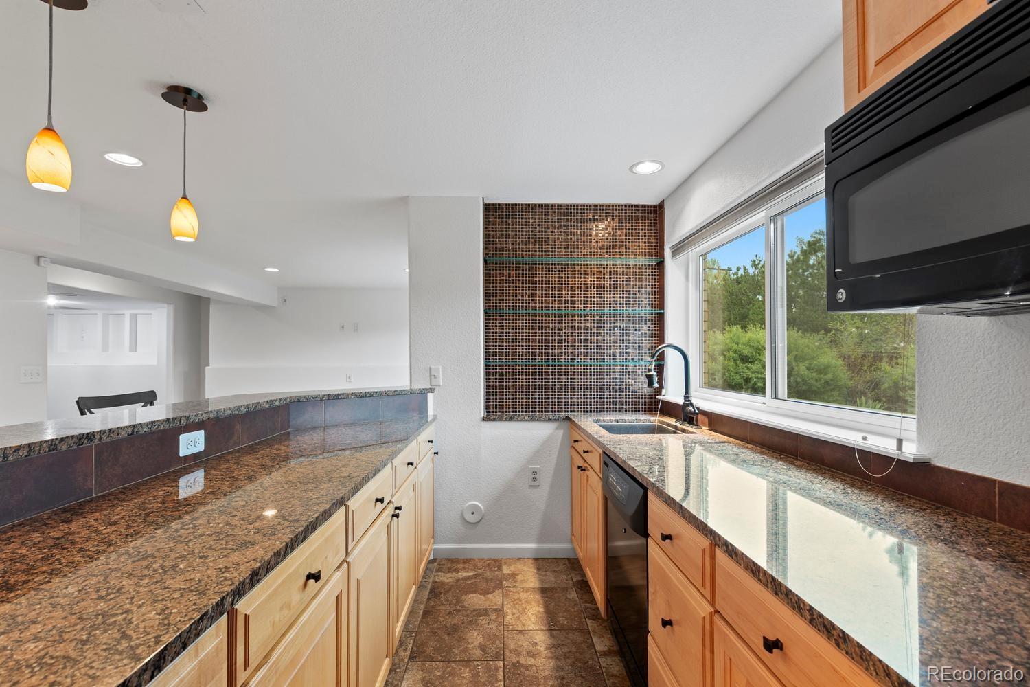 3900 Pierson Street Wheat Ridge, CO 80033 - Photo 28 of 39 a kitchen with a sink stove and cabinets