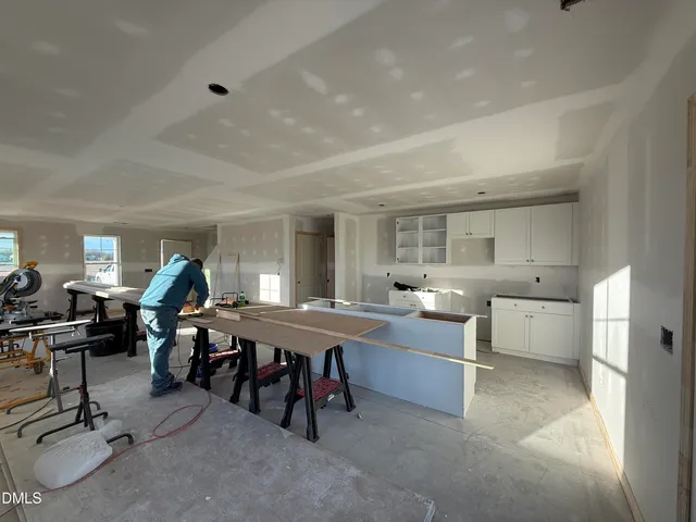 a living room with furniture a air conditioner and a table