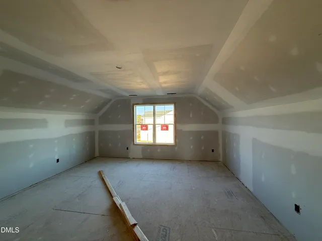 an empty room with a empty space and windows