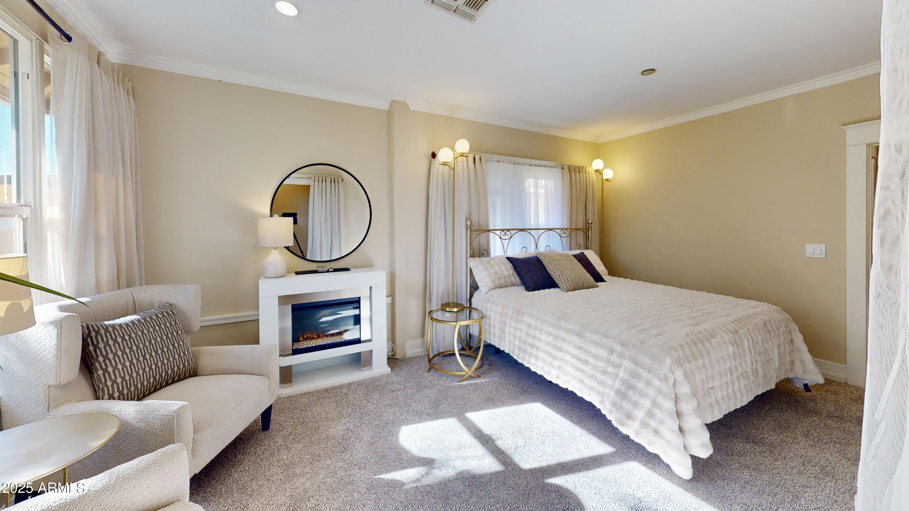 723 East Moreland Street Phoenix, AZ 85006 - Photo 15 of 25 a bed room with a bed furniture and a fireplace