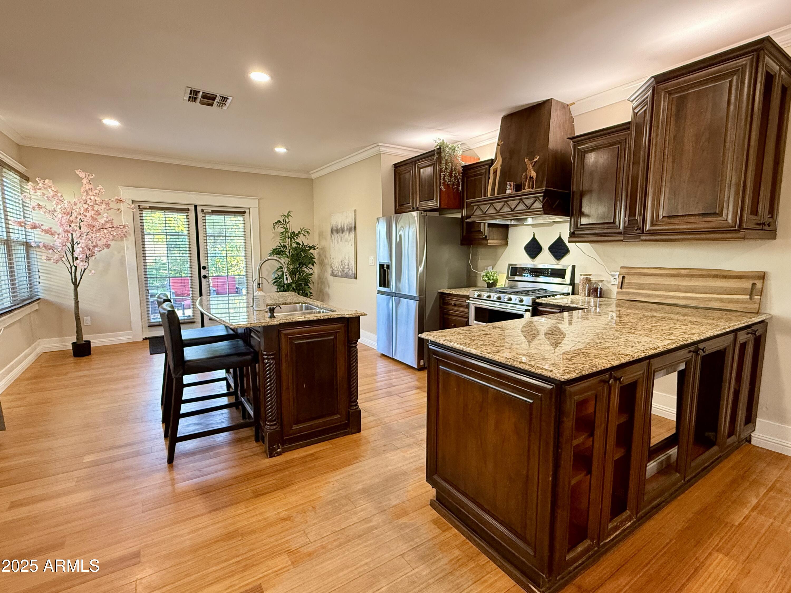 723 East Moreland Street Phoenix, AZ 85006 - Photo 9 of 25 a kitchen with sink stove and wooden cabinets