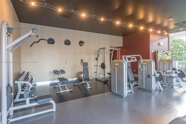 a gym room with lots of gym equipment