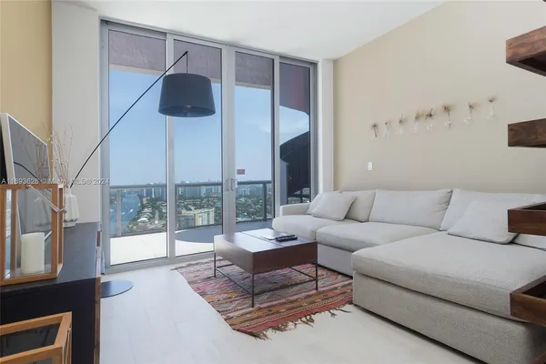 a living room with furniture and a large window