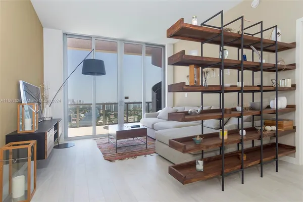 a balcony with furniture and a book shelf