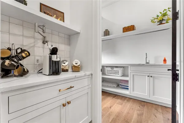 a living room with furniture and large windows