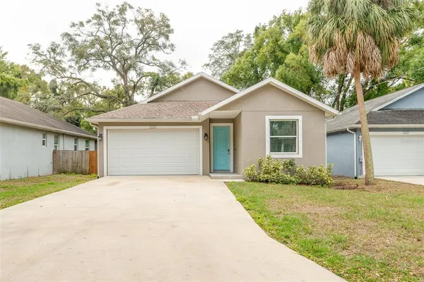 a front view of a house with a yard and garage