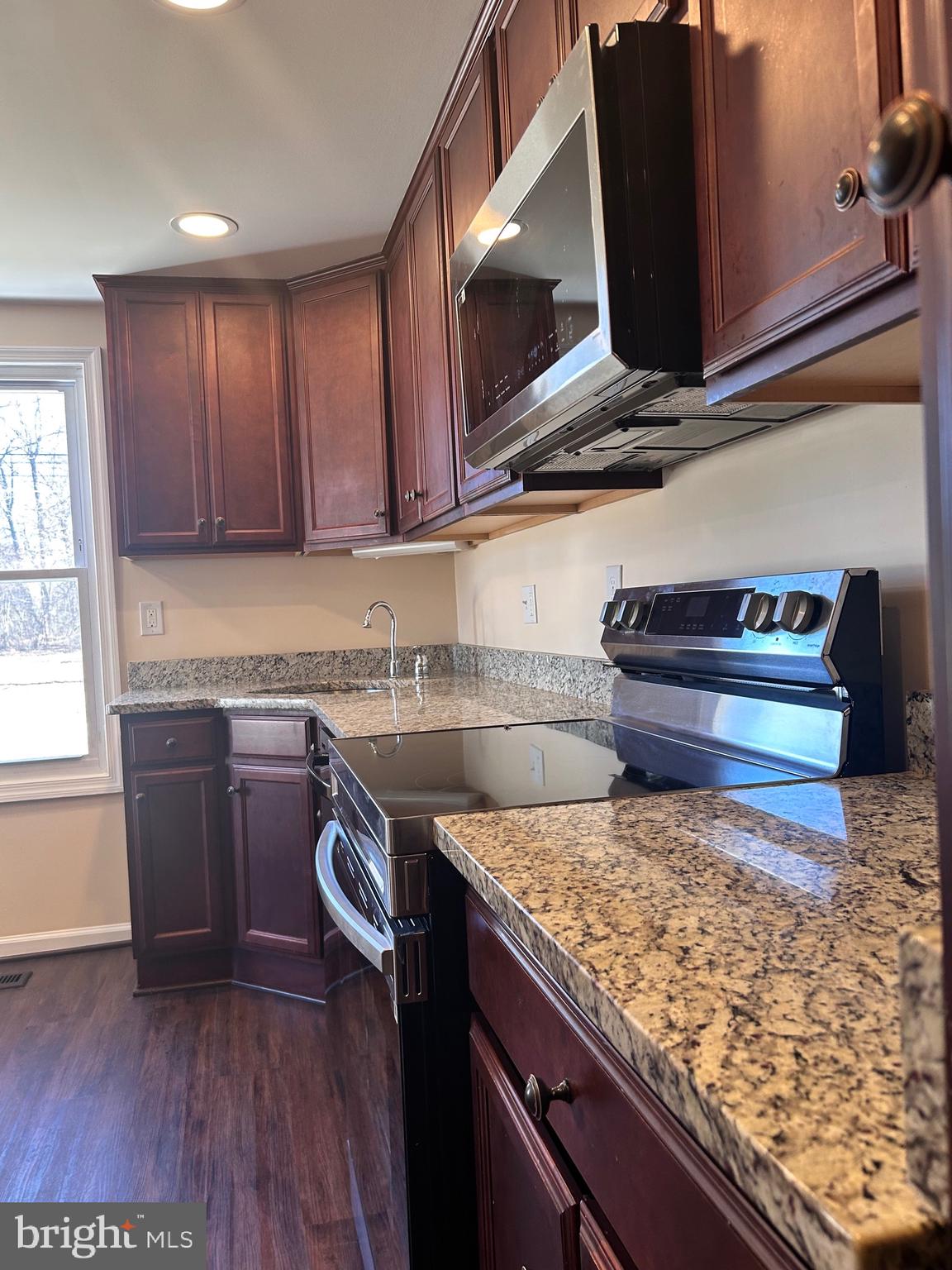 7617 Windsor Mill Road Windsor Mill, MD 21244 - Photo 12 of 49 a kitchen with a sink a stove and cabinets