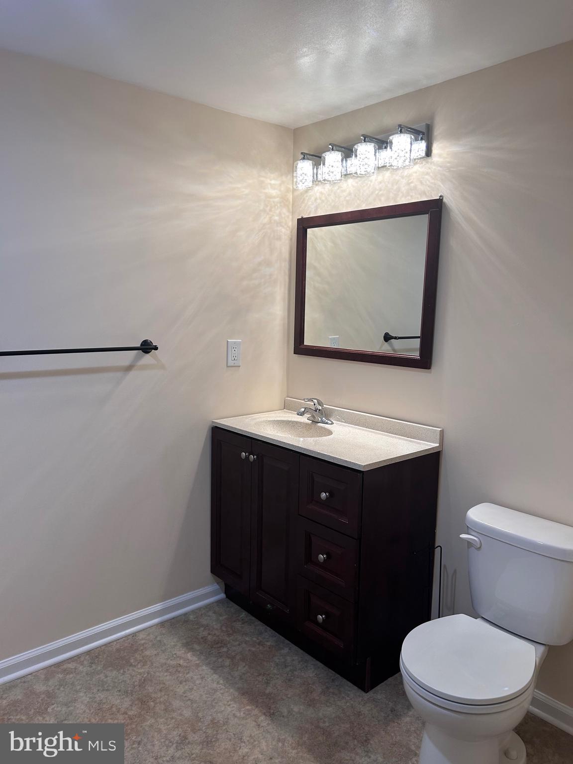 7617 Windsor Mill Road Windsor Mill, MD 21244 - Photo 22 of 49 a bathroom with a sink vanity mirror and toilet
