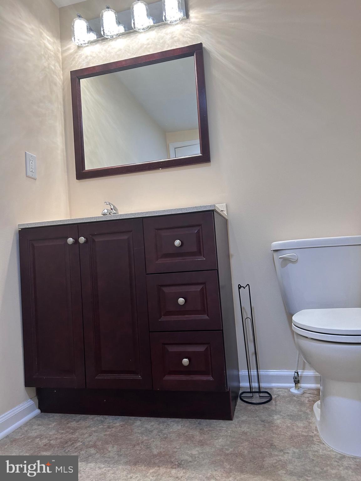 7617 Windsor Mill Road Windsor Mill, MD 21244 - Photo 23 of 49 a bathroom with a toilet a sink and mirror