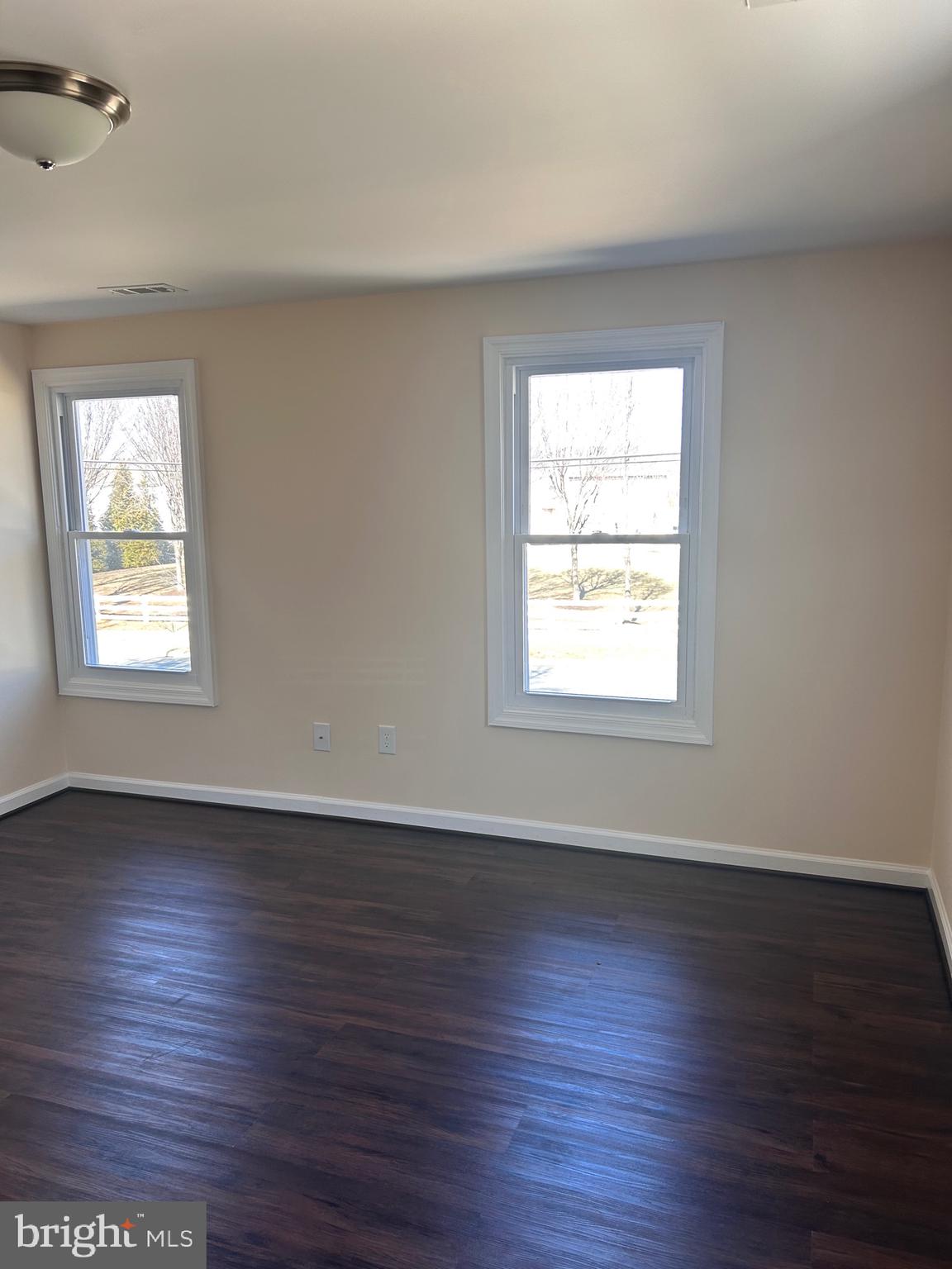 7617 Windsor Mill Road Windsor Mill, MD 21244 - Photo 26 of 49 an empty room with wooden floor and windows
