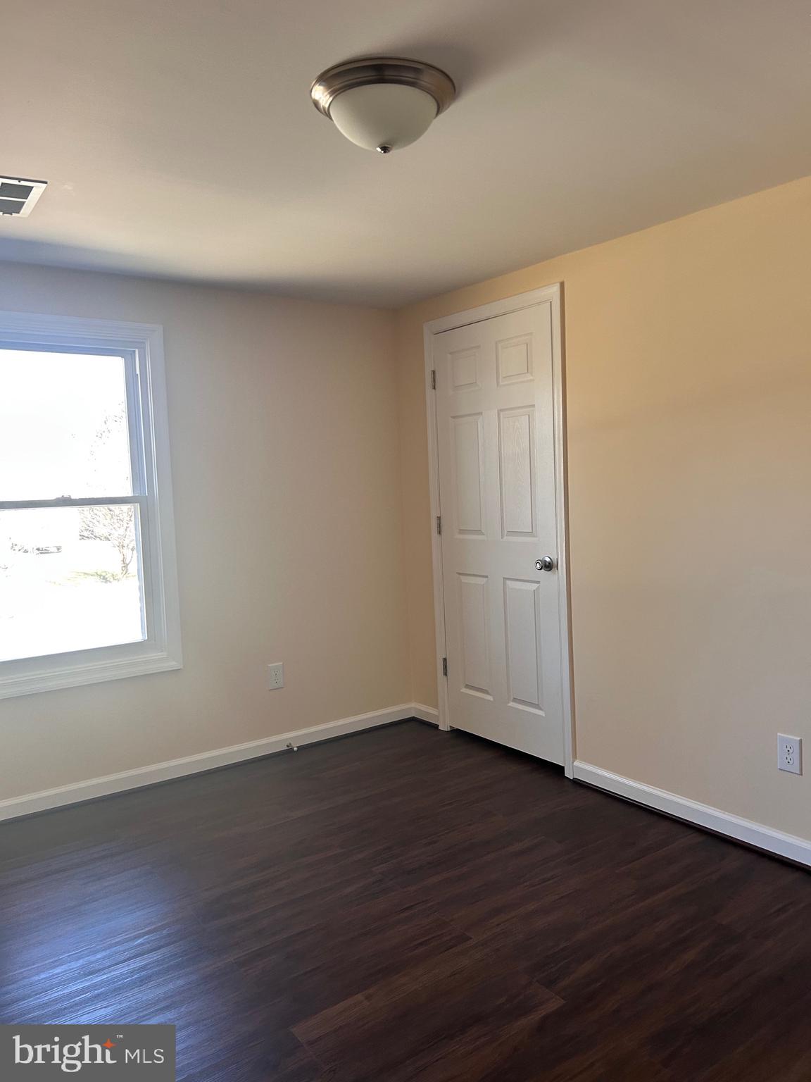 7617 Windsor Mill Road Windsor Mill, MD 21244 - Photo 27 of 49 an empty room with wooden floor and windows