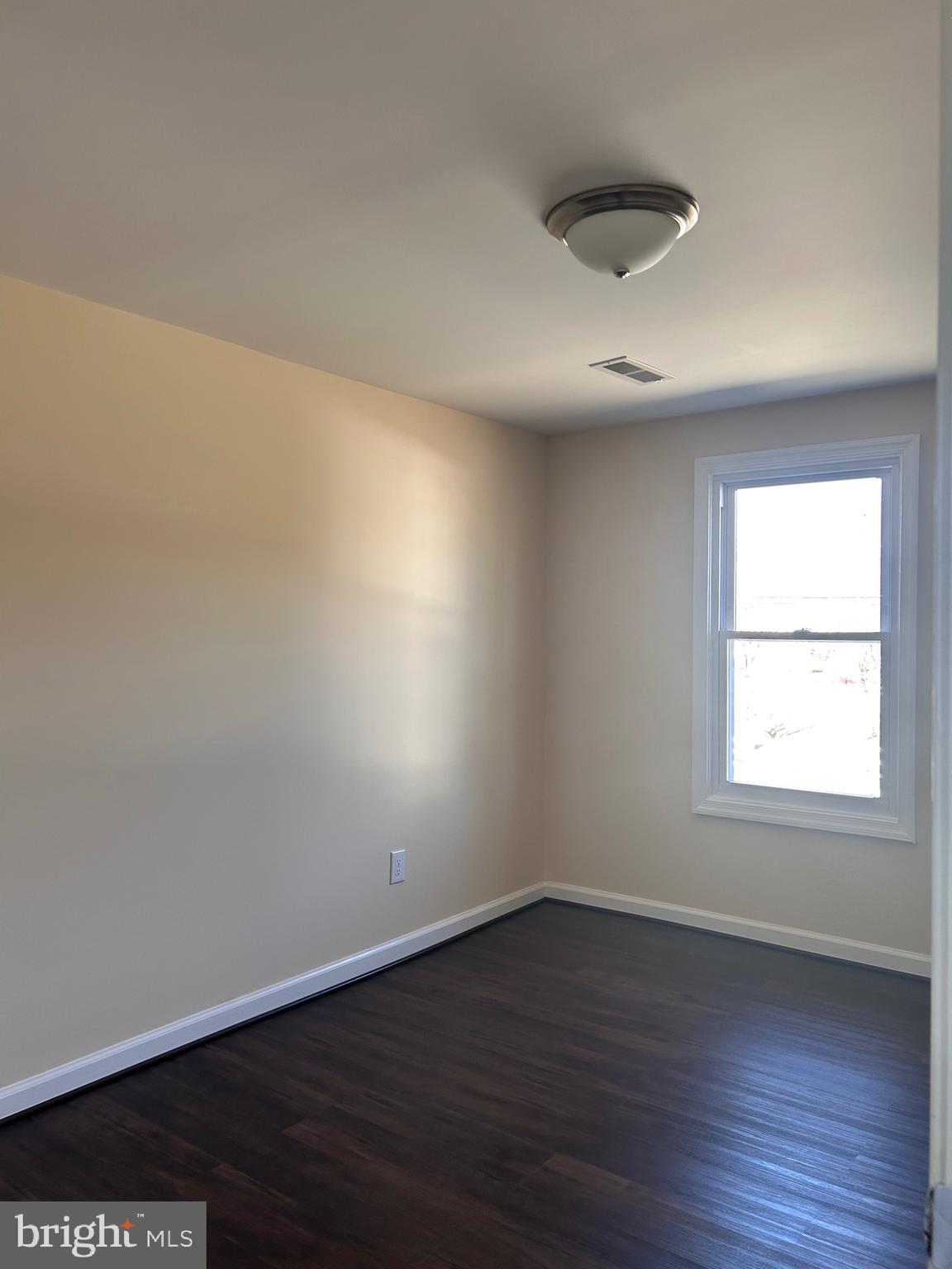 7617 Windsor Mill Road Windsor Mill, MD 21244 - Photo 28 of 49 an empty room with wooden floor and windows