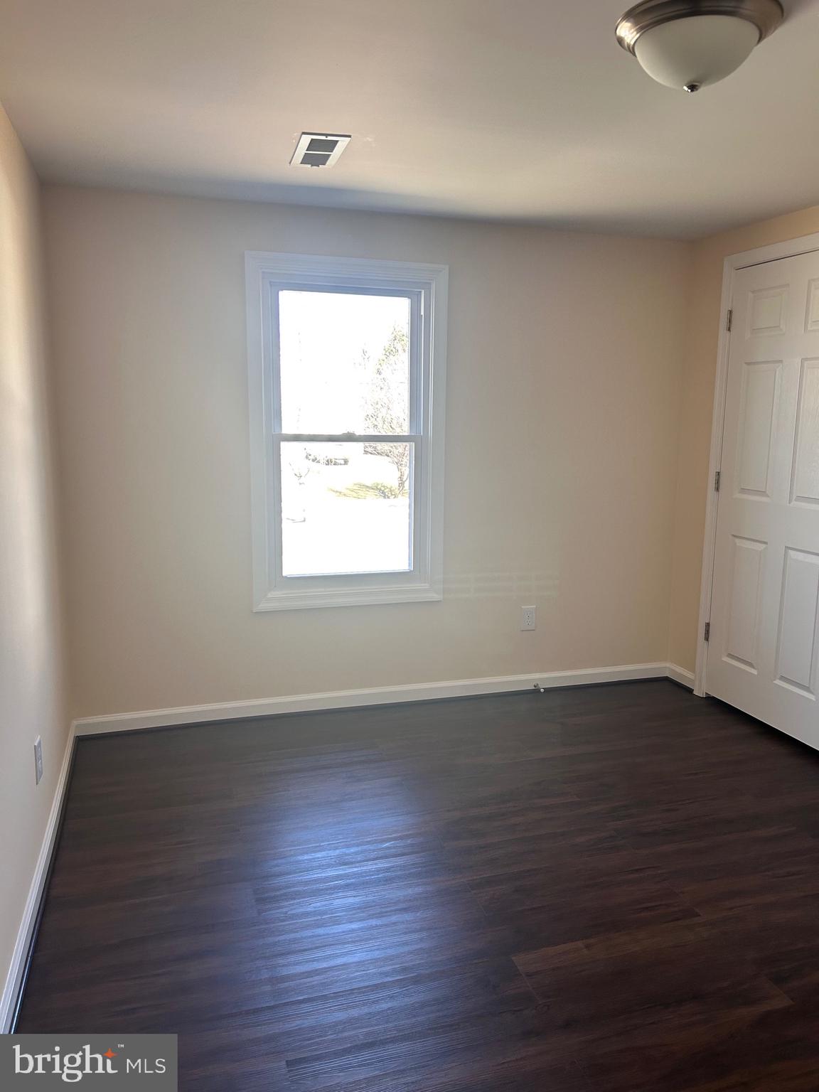 7617 Windsor Mill Road Windsor Mill, MD 21244 - Photo 31 of 49 an empty room with wooden floor and windows