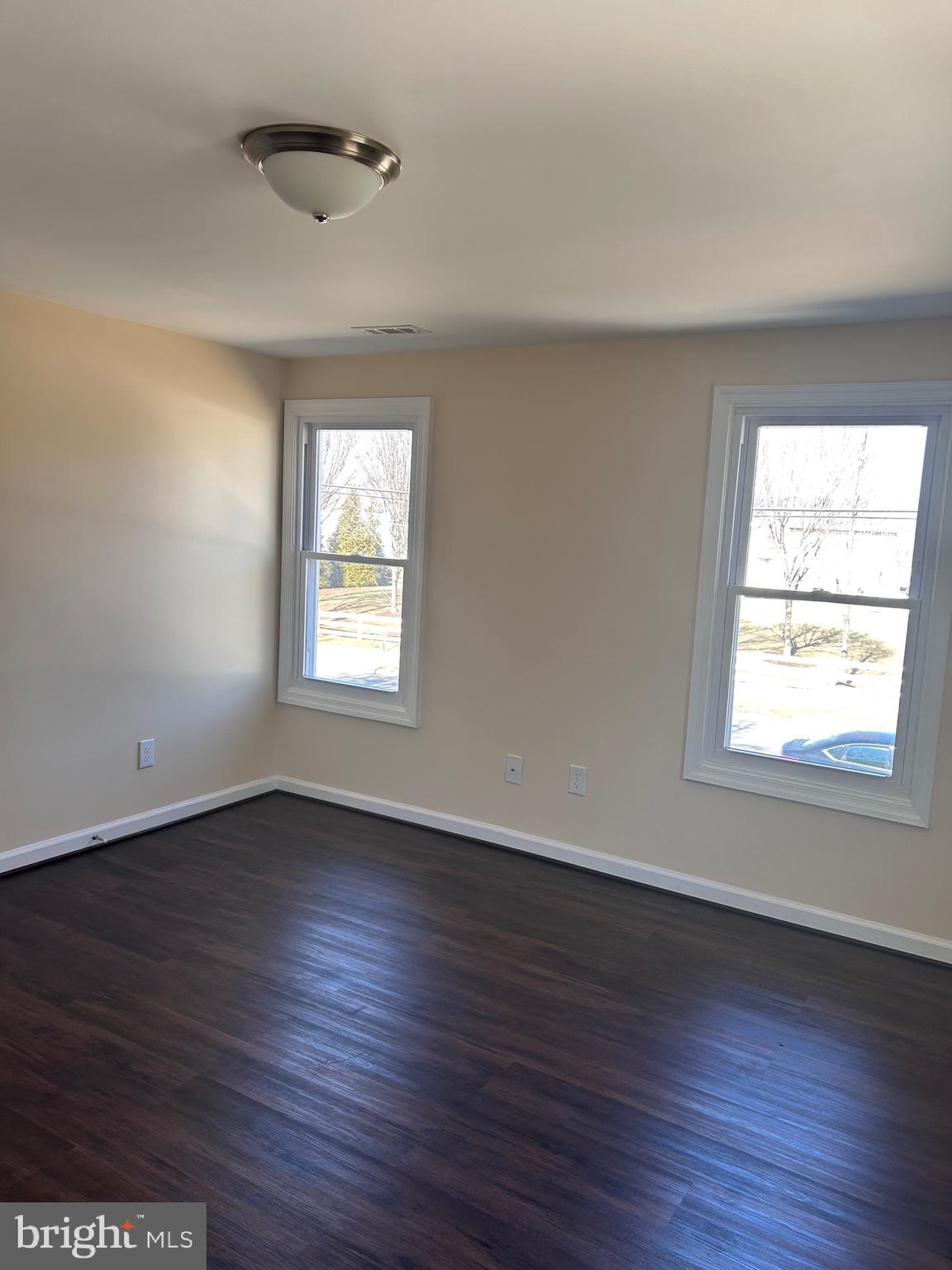 7617 Windsor Mill Road Windsor Mill, MD 21244 - Photo 33 of 49 an empty room with wooden floor and windows