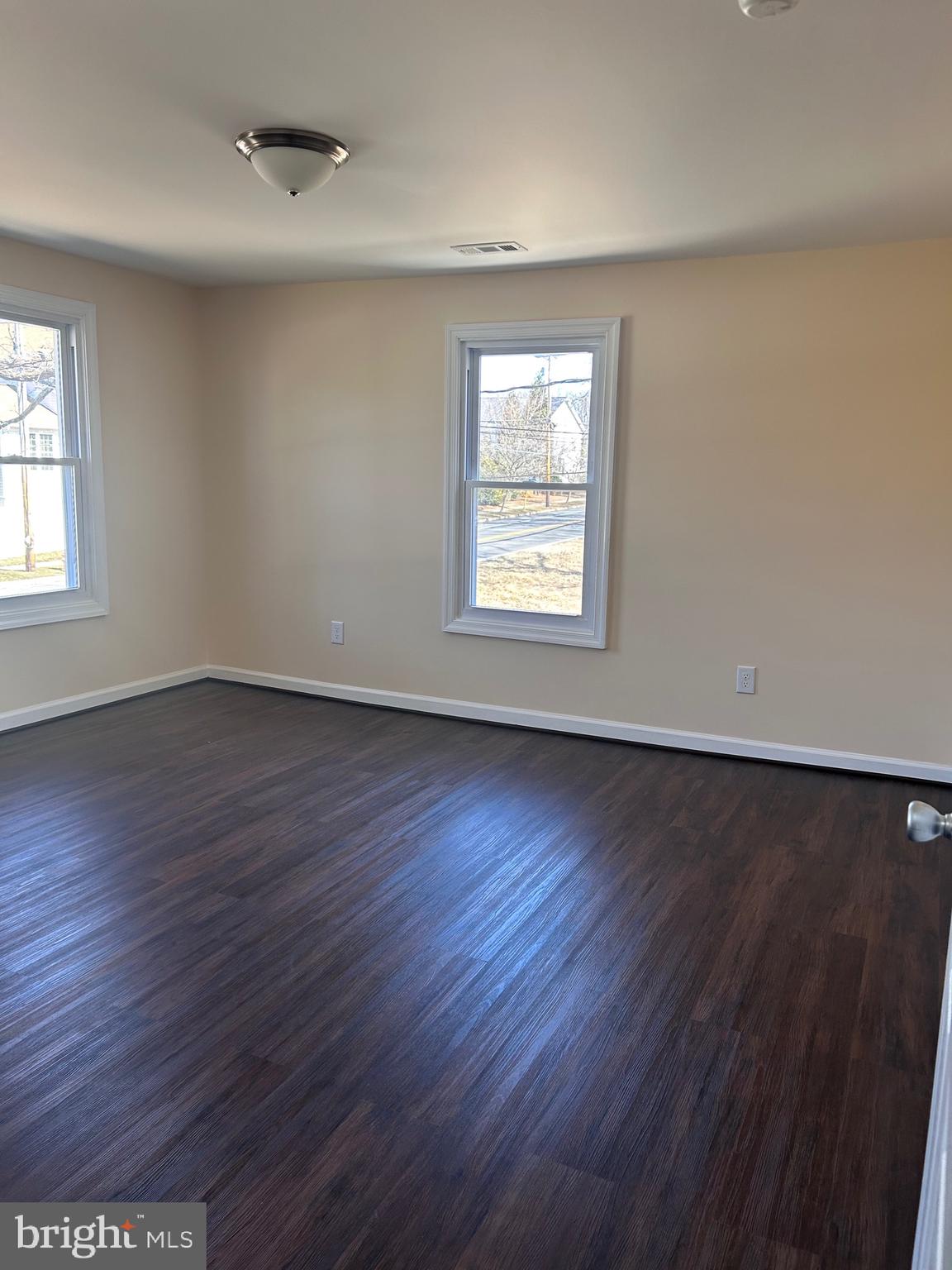 7617 Windsor Mill Road Windsor Mill, MD 21244 - Photo 34 of 49 an empty room with wooden floor and windows