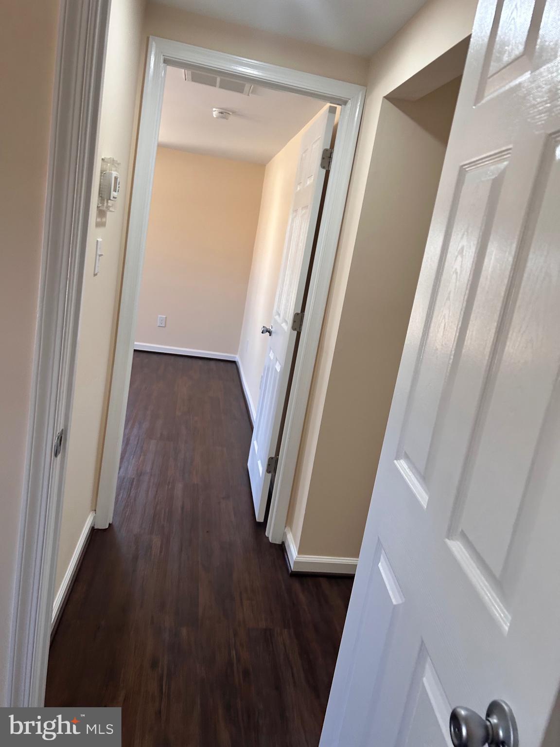 7617 Windsor Mill Road Windsor Mill, MD 21244 - Photo 35 of 49 a view of a hallway with wooden floor and stairs