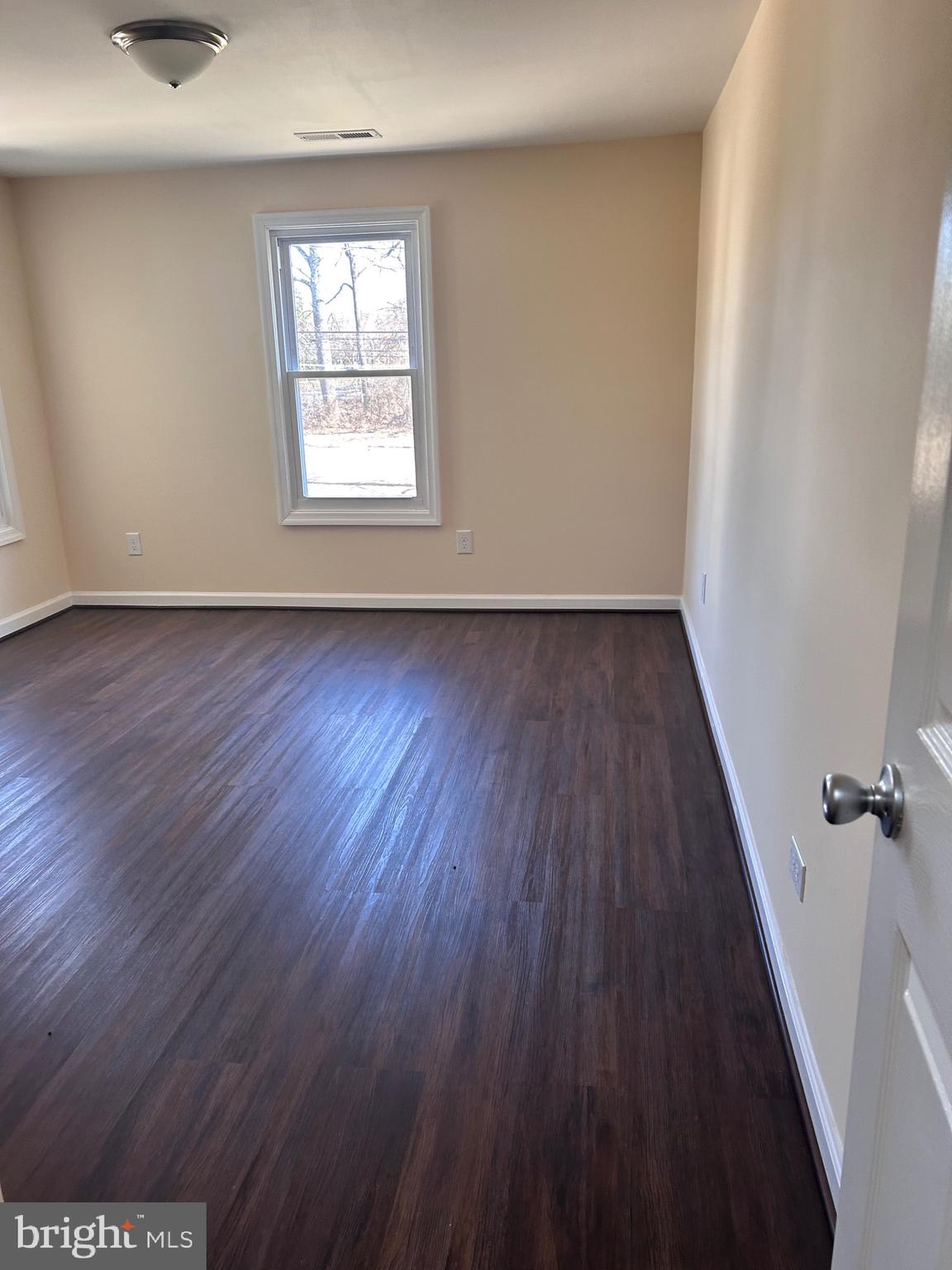 7617 Windsor Mill Road Windsor Mill, MD 21244 - Photo 36 of 49 an empty room with wooden floor and windows