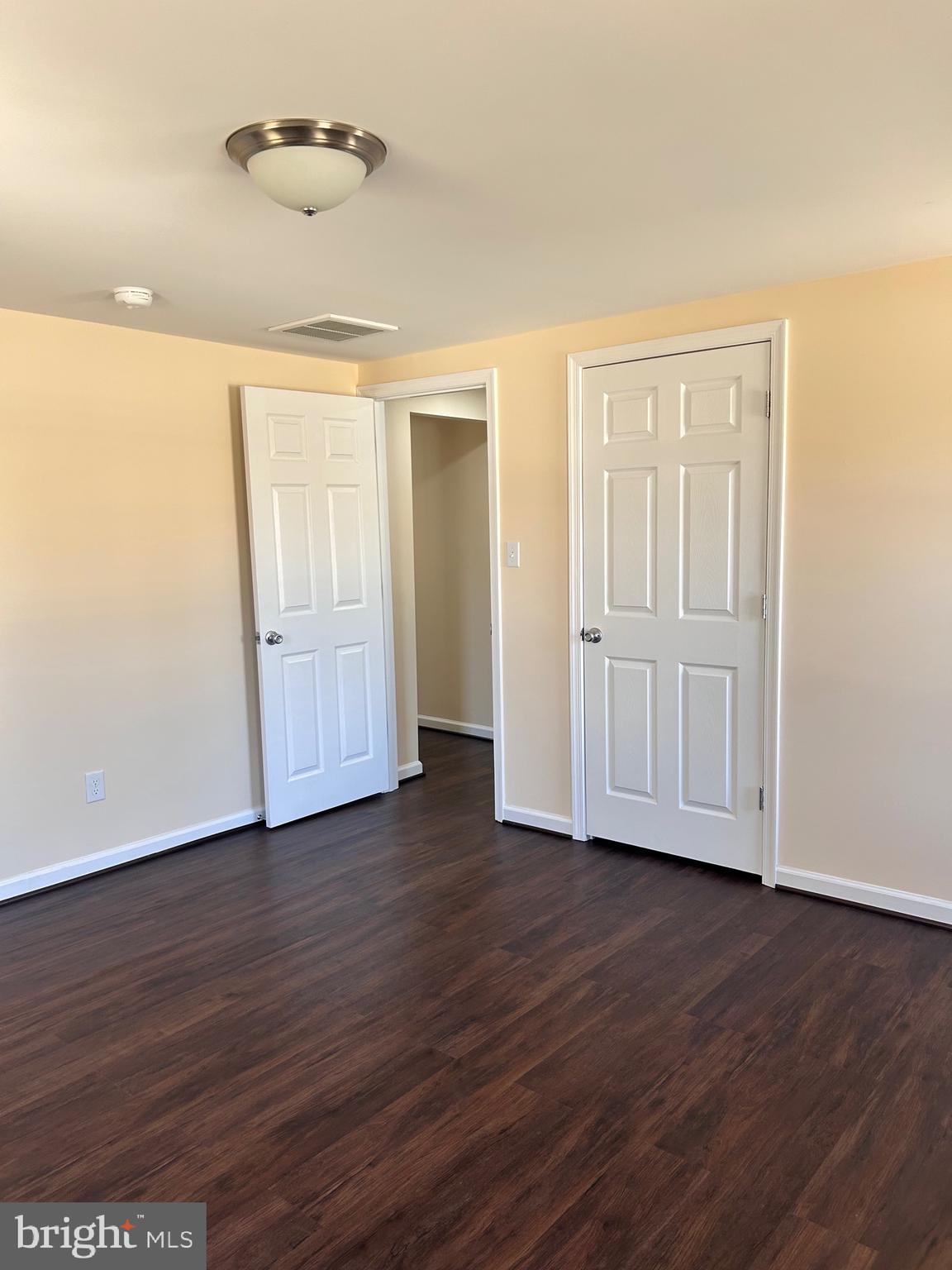 7617 Windsor Mill Road Windsor Mill, MD 21244 - Photo 37 of 49 an empty room with wooden floor and windows
