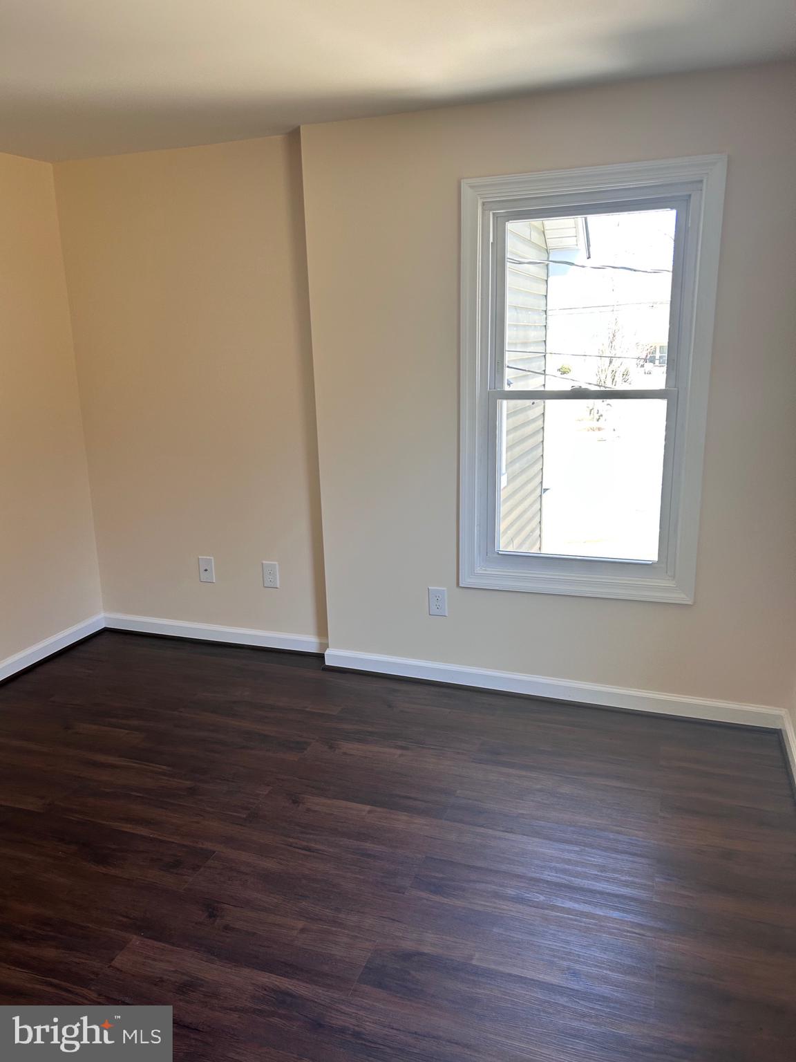7617 Windsor Mill Road Windsor Mill, MD 21244 - Photo 39 of 49 a view of an empty room with wooden floor and a window