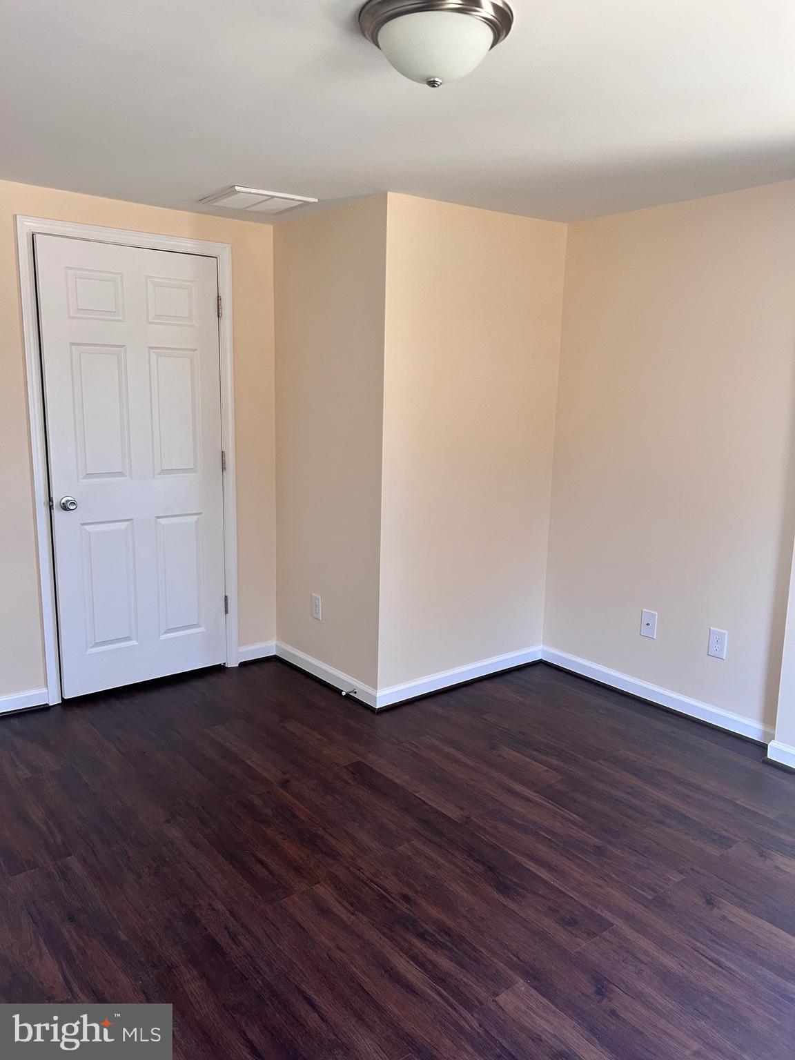 7617 Windsor Mill Road Windsor Mill, MD 21244 - Photo 40 of 49 a view of an empty room with wooden floor and a window